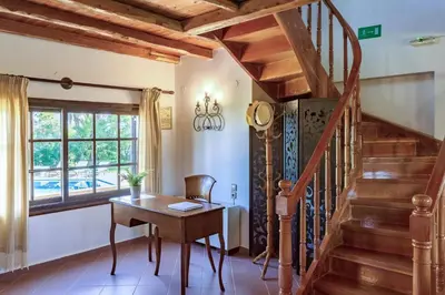 a room with a wooden staircase and a desk at Exclusive Crete Villa Villa Alexia 4 Bedrooms Large Lawned Gardens in Maleme