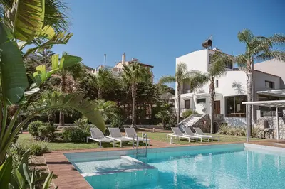 a swimming pool with lounge chairs and a house at Villa Anemeli - Luxury pool villa with gorgeous seaview in Kissamos