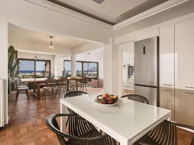 a kitchen and dining room with a table and chairs at Villa Anemeli - Luxury pool villa with gorgeous seaview in Kissamos