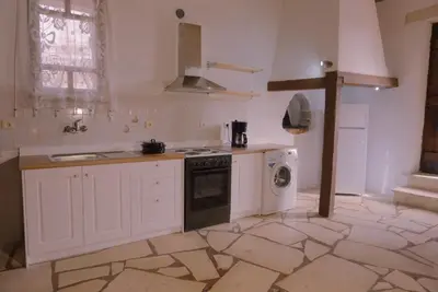 a kitchen with white cabinets and a sink and a stove at Villa Kamares Private pool in Kondomari