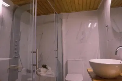 a bathroom with a sink and a glass shower at Villa Kamares Private pool in Kondomari