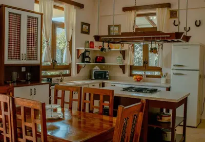a kitchen with a table and chairs and a refrigerator at Villa Kalamitsi Luxury Villa in Apokorona Chania in Kariá