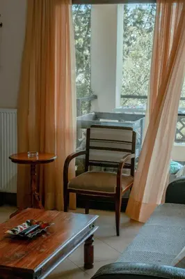 a living room with a chair and a table at Villa Kalamitsi Luxury Villa in Apokorona Chania in Kariá