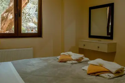 a bedroom with a bed with two towels on it at Villa Kalamitsi Luxury Villa in Apokorona Chania in Kariá