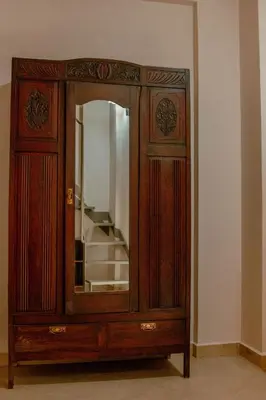 a wooden cabinet with a mirror in a room at Villa Kalamitsi Luxury Villa in Apokorona Chania in Kariá