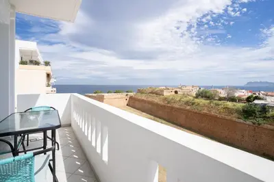 a balcony with a table and a view of the ocean at Lektron Apartment in Chania Town