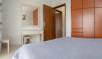 a bedroom with a bed and a sink and a mirror at Lektron Apartment in Chania Town