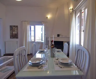 a dining room table with plates and napkins on it at Villa Maragoudi in Arménoi