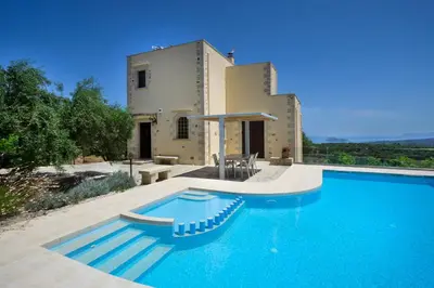 a villa with a swimming pool in front of a house at Casa Rustica in Xirokámbion