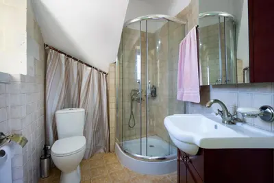 a bathroom with a toilet and a sink and a shower at Casa Rustica in Xirokámbion