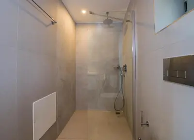 a shower with a glass door in a bathroom at Petras Resort in Falasarna