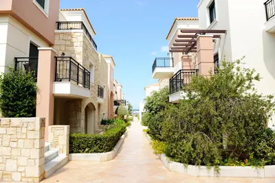 a walkway between two apartment buildings at Caldera Bay in Plataniás