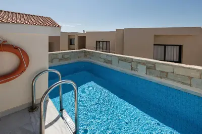 a swimming pool on the side of a building at Caldera Bay in Plataniás