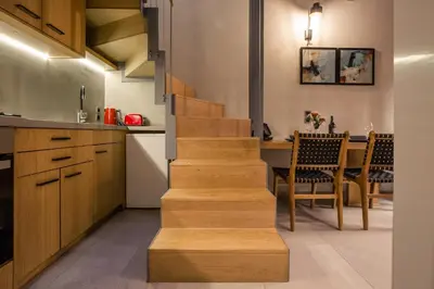 a staircase in a kitchen with a table and chairs at The Peach House in Chania Town