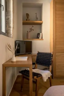 a room with a desk with a computer and a chair at The Peach House in Chania Town