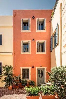 an orange building with plants in front of it at The Peach House in Chania Town