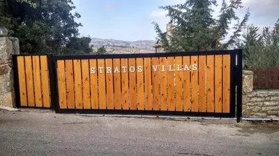 a wooden gate with the words staci villas written on it at Stratos Villas in Melidhónion