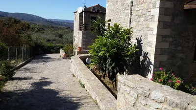 a stone walkway next to a building with plants at Stratos Villas in Melidhónion