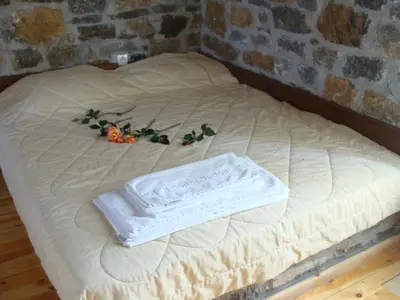a white bed with some vegetables on top of it at Stratos Villas in Melidhónion