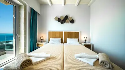 a bedroom with a large bed with a large window at Nafsika Xenia Villa in Plátanos