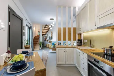 a kitchen with a table with a bowl of fruit on it at Villa Chryssi in Kissamos