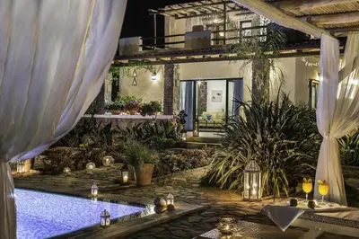 a swimming pool in a house with lights and candles at Villa Kalithea in Pemónia