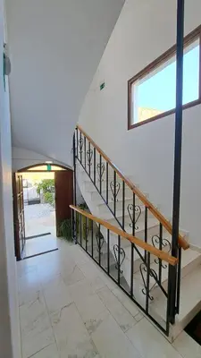 a staircase in a house with a window at Artemis Studios in Agia Roumeli