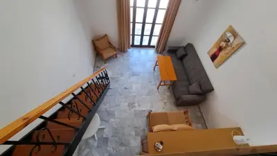 an overhead view of a living room with a couch at Artemis Studios in Agia Roumeli
