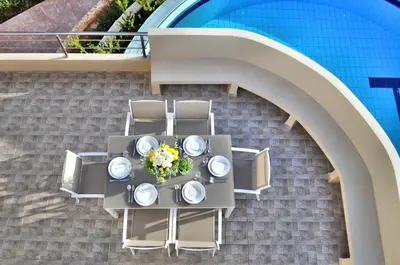an overhead view of a table with plates and chairs at Anemon Villas in Kissamos