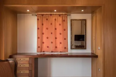 a bathroom with an orange shower curtain and a sink at Athina Luxury Villas in Xamoudhokhórion