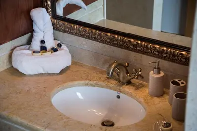 a bathroom counter with a sink and a mirror at Athina Luxury Villas in Xamoudhokhórion