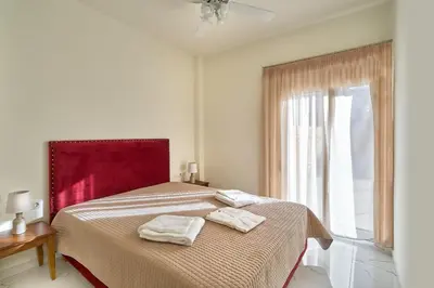 a bedroom with a bed with two towels on it at Villa Calliope in Chania Town