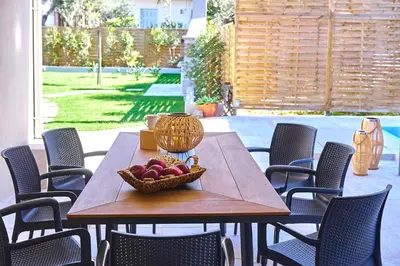 a wooden table with a bowl of fruit on it at Villa Calliope in Chania Town