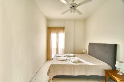 a bedroom with a bed with a ceiling fan at Villa Calliope in Chania Town