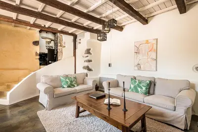 a living room with two couches and a coffee table at Verekinthos Villas - Pool, Hot Tub, BBQ, Kids Playground, Stunning Mountain Views in Gerolakkos