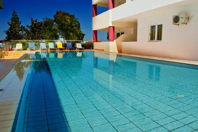 a swimming pool in front of a house at Thodorou Village in Agia Marina Nea Kydonias