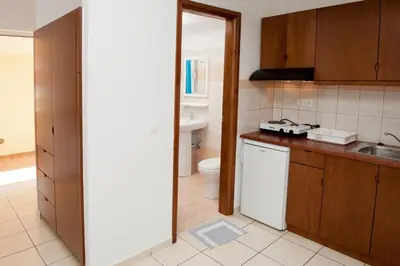 a small kitchen with a sink and a toilet at Thodorou Village in Agia Marina Nea Kydonias