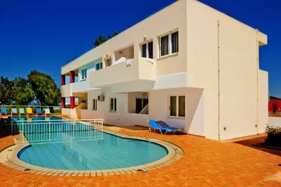 a house with a swimming pool in front of it at Thodorou Village in Agia Marina Nea Kydonias