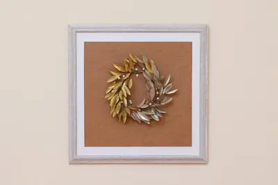 a framed picture of a wreath on a wall at Zefyros Apartments and House in Kissamos