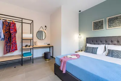 a bedroom with a blue bed and a mirror at Villa Vega I 