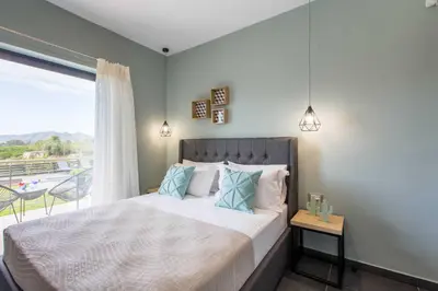 a bedroom with a large bed and a balcony at Villa Vega I 