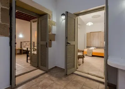 a room with a door leading to a bedroom at Basilikos traditional house, 10' from Falasarna in Kissamos