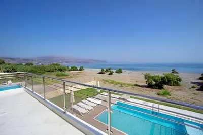 a balcony with a view of the ocean at Beach Villas in Chania Town