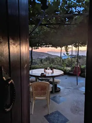 a patio with a table and a table and a chair at TRADITIONAL HOUSE MARIA in Azoyirás