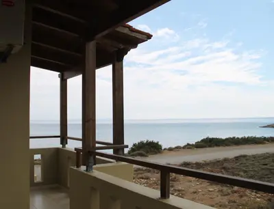 a view of the ocean from the balcony of a house at Argilos Apartments in Frangokastello