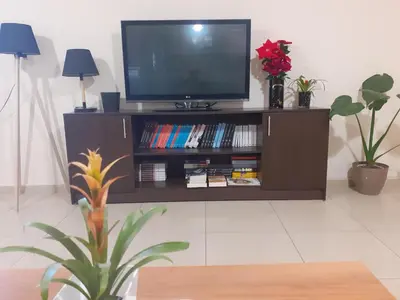 a entertainment center with a television and books at House escape in Chania Town