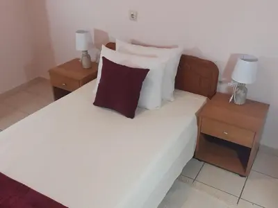 a bedroom with a bed with two night stands at House escape in Chania Town