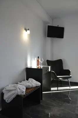 a room with a desk and a chair and a table at Odos Oneiron Tavronitis Bay in Tavronitis