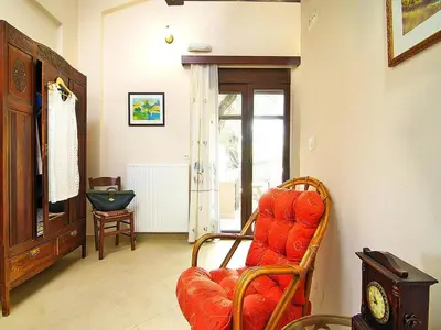 a living room with an orange chair and a window at Holiday home with pool in Kalamítsion Alexándrou
