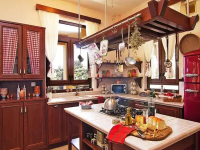 a kitchen with wooden cabinets and a counter top at Holiday home with pool in Kalamítsion Alexándrou